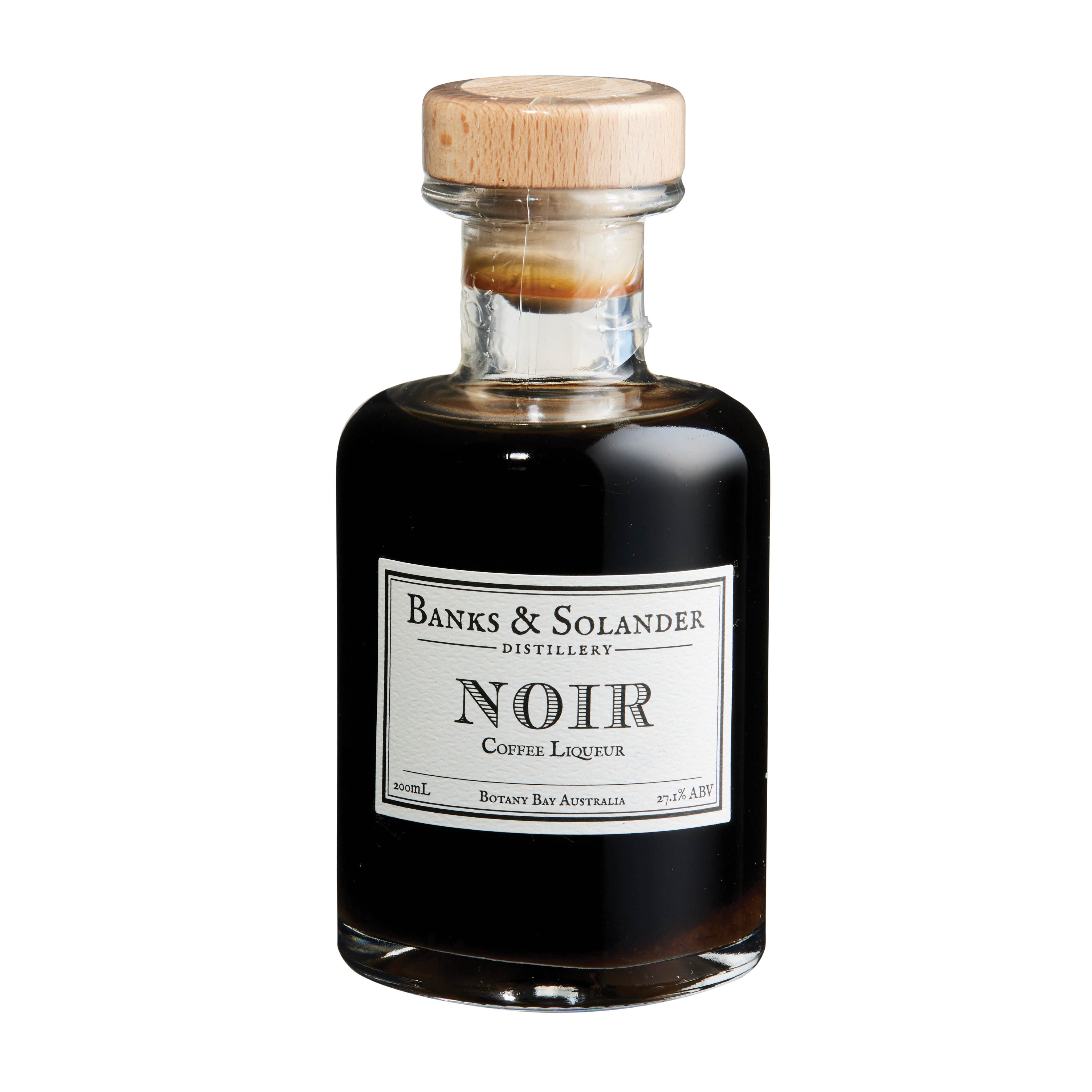 A bottle of Banks & Solander Noir Coffee Liqueur. The bottle is clear and shows the dark brown liqueur inside. The label reads "Noir Coffee Liqueur" and "Botany Bay Australia." The bottle is 200ml and has an alcohol content of 27.1%.