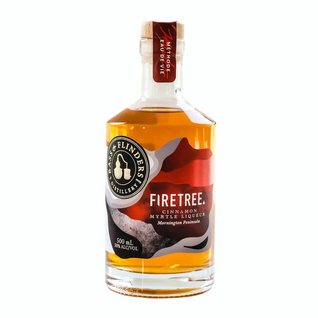 A bottle of Bass & Flinders Firetree Cinnamon Myrtle Liqueur. The bottle is clear and shows the orange-colored liqueur inside. The label reads "Firetree Cinnamon Myrtle Liqueur" and "Mornington Peninsula." The bottle is 500ml and has an alcohol content of