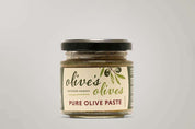 A glass jar of "Olive's Olives" Pure Olive Paste from the Macedon Ranges. The jar is filled with a dark green paste and has a black lid. The label features a hand-drawn illustration of olives and the words "Pure Olive Paste" in a handwritten style.