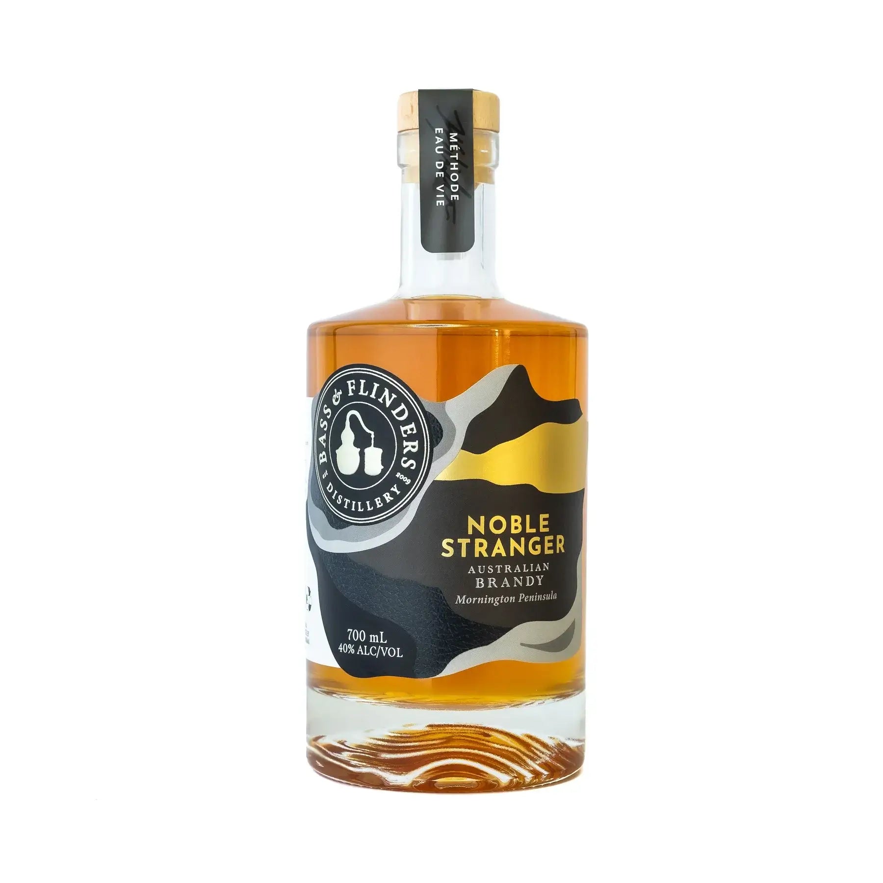 A bottle of Bass & Flinders Noble Stranger Australian Brandy. The bottle is clear and shows the amber-colored brandy inside. The label reads "Noble Stranger Australian Brandy" and "Mornington Peninsula." The bottle is 700ml and has an alcohol content of 4