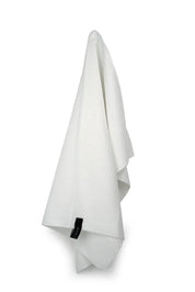 A white microfiber tea towel hanging against a white background. It has a small black "Barkly" tag attached.