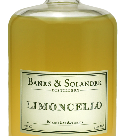 A bottle of Banks & Solander Limoncello. The bottle is clear and shows the bright yellow liqueur inside. The label reads "Limoncello" and "Botany Bay Australia." The bottle is 700ml and has an alcohol content of 25%.