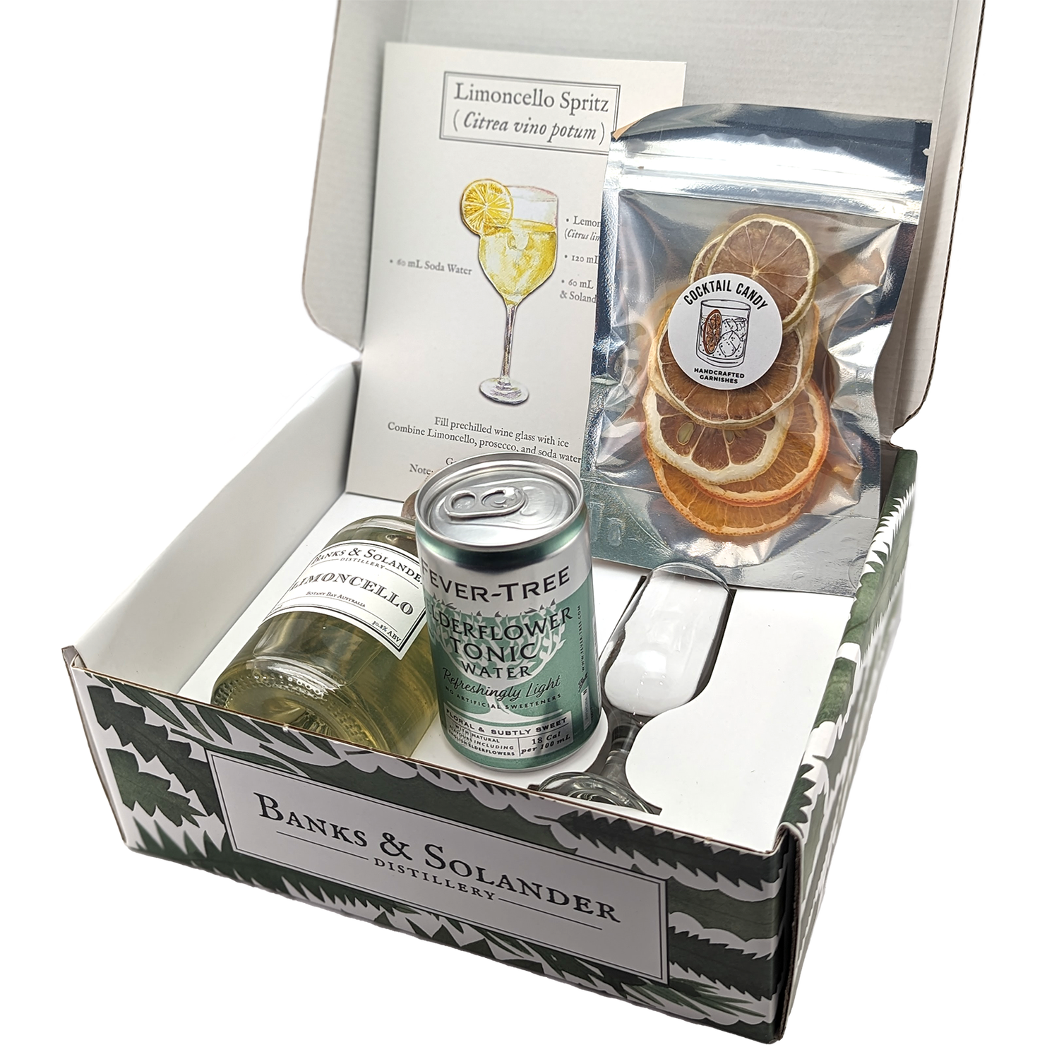 A gift box containing all the ingredients to make a Limoncello Spritz cocktail. Inside are miniature bottles of Banks & Solander Limoncello, a can of Ever-Tree Elderflower Tonic, dehydrated citrus slices, and a recipe card.