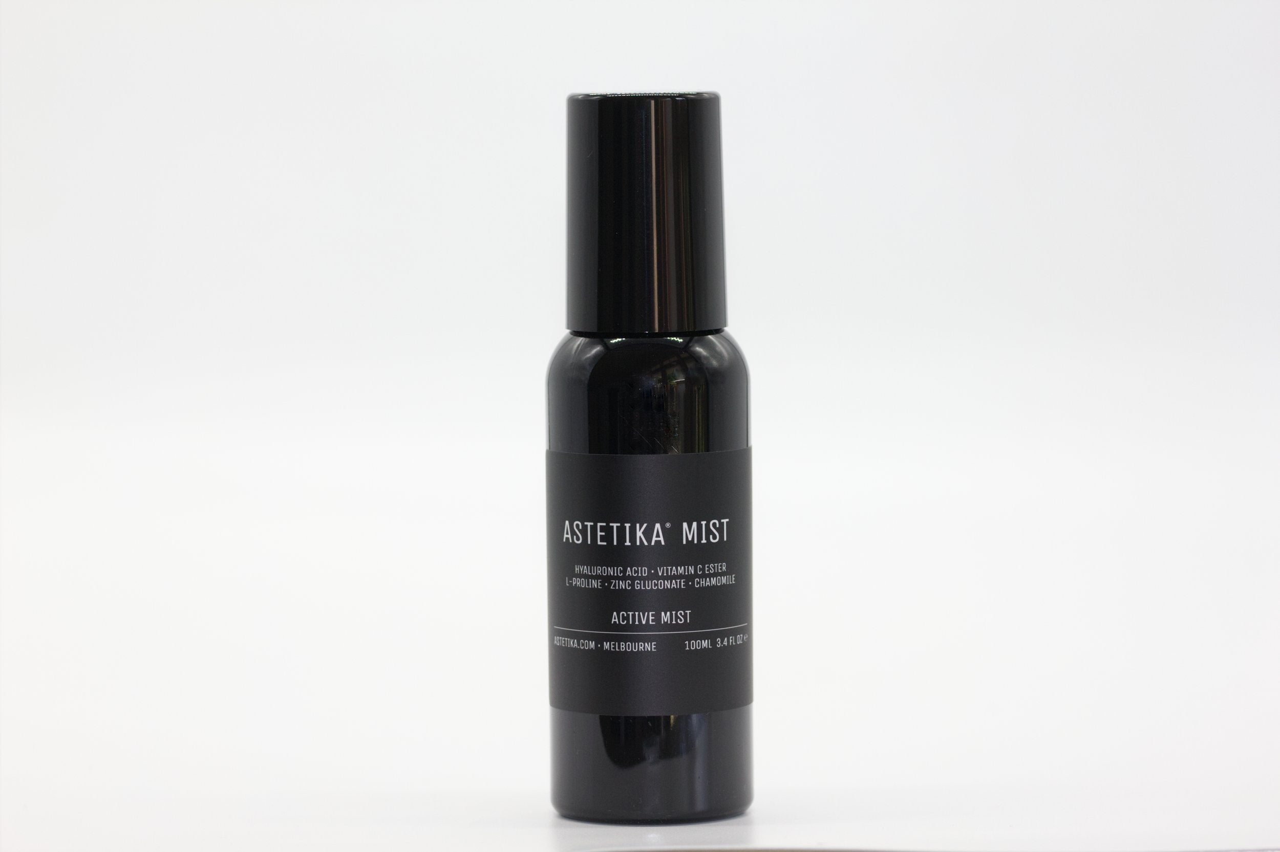 A black bottle with a black cap, labelled &quot;Astetika Mist&quot;. It appears to be a skincare product, likely a facial mist, with ingredients including hyaluronic acid, vitamin C, and zinc. The bottle is 200ml.