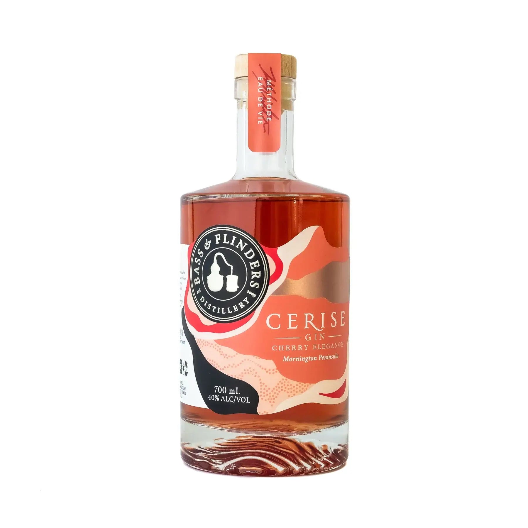 A bottle of Bass & Flinders Cerise Gin. The bottle is clear and shows the pink-hued gin inside. The label reads "Cerise Gin" and "Cherry Elegance." The bottle is 700ml and has an alcohol content of 40%. It is made on the Mornington Peninsula.